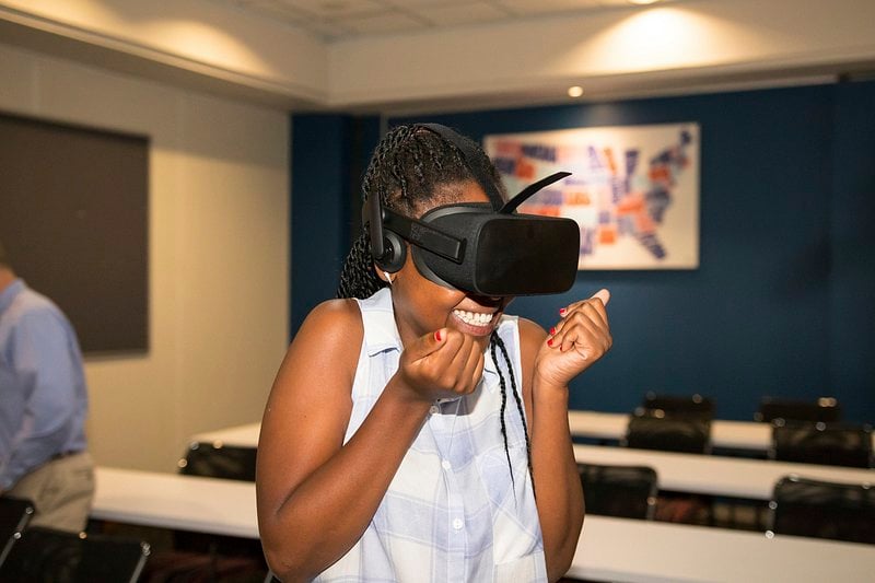 A girl in classroom experiencing the thrill of virtual reality