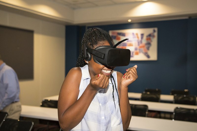 A girl in classroom experiencing the thrill of virtual reality